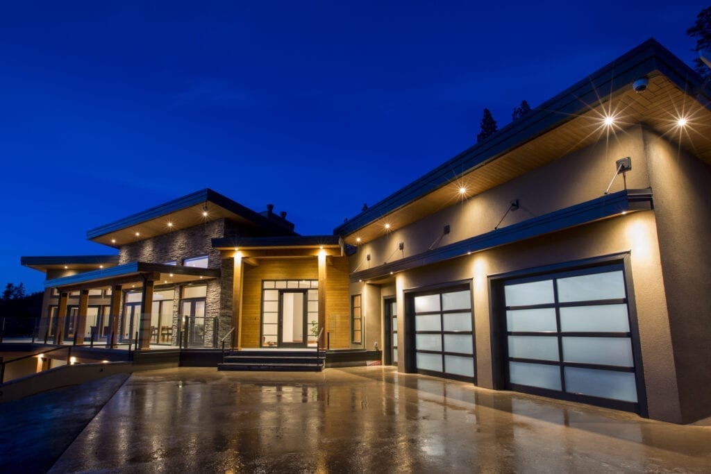 Large Modern Home Exterior at night by Solaris Luxury Builders